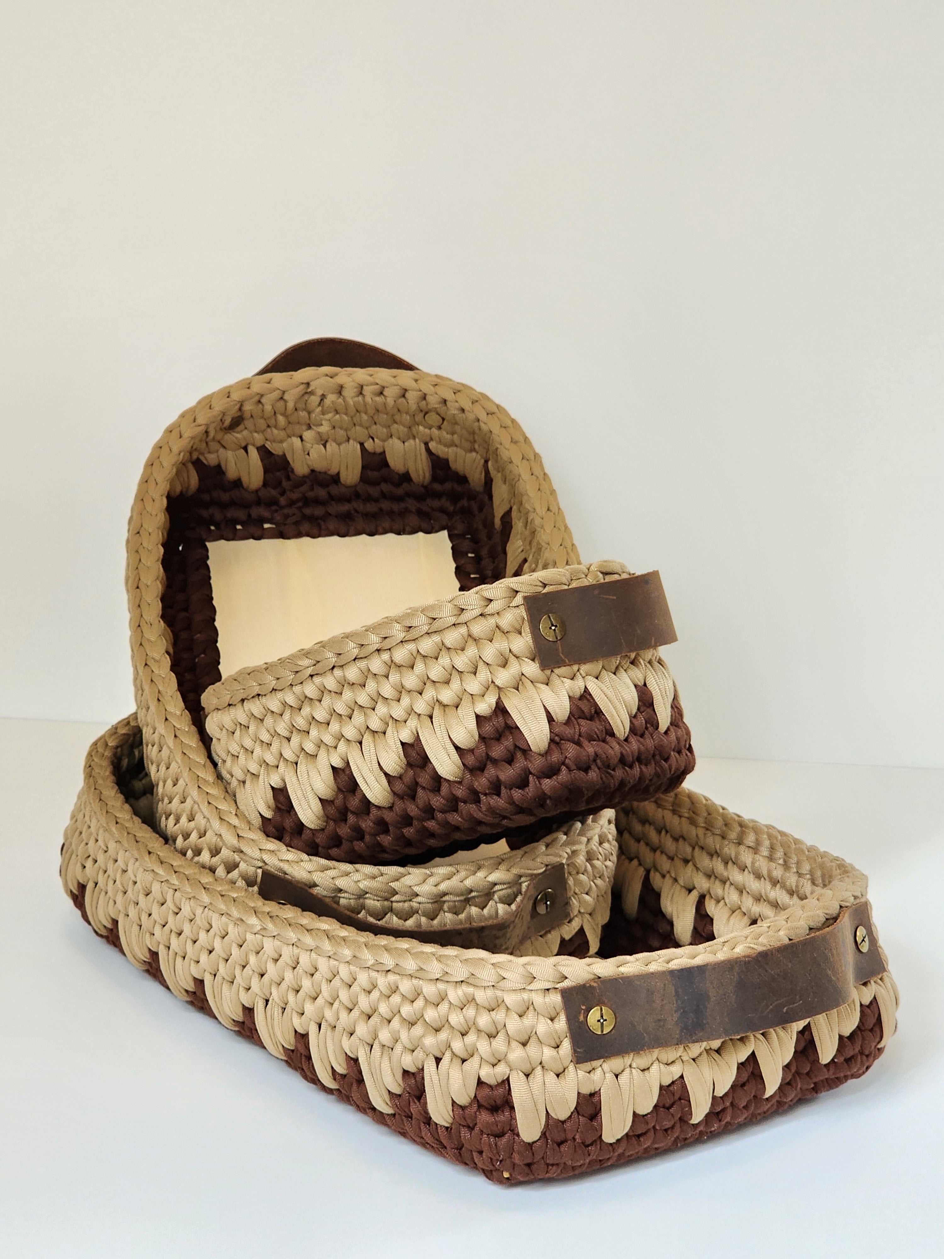 Woven basket set with brown and beige pattern on a white background