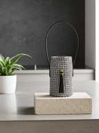 wine caddy in pewter color with black handle and ornament